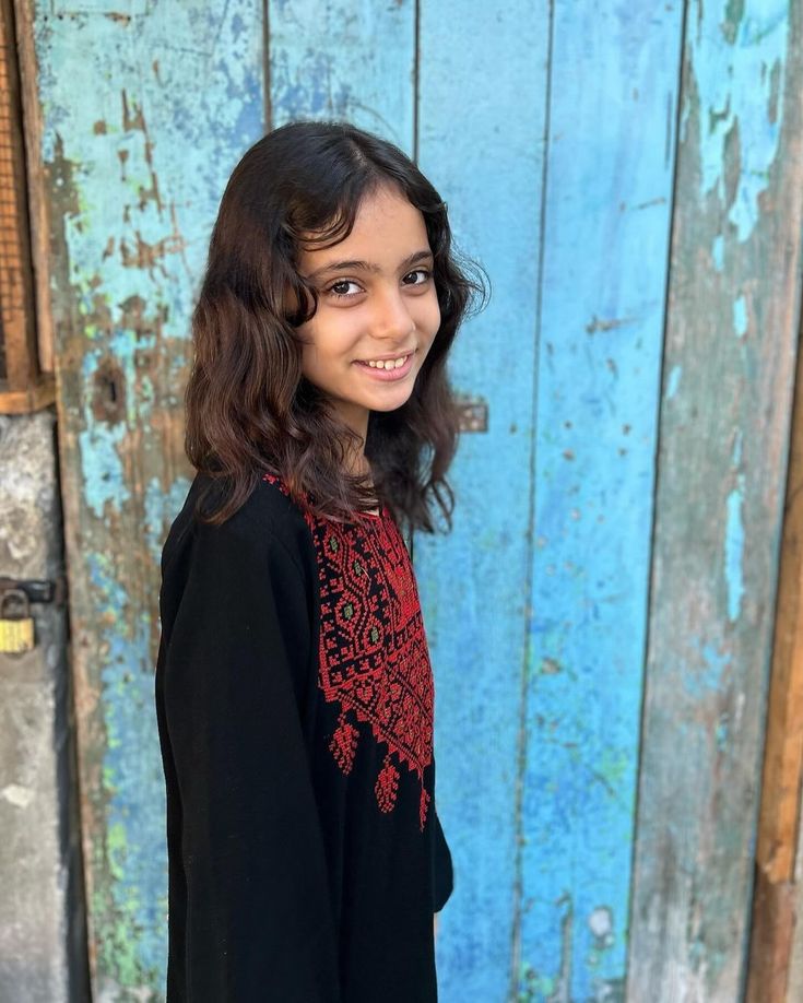 Palestinian girl with school supplies and books