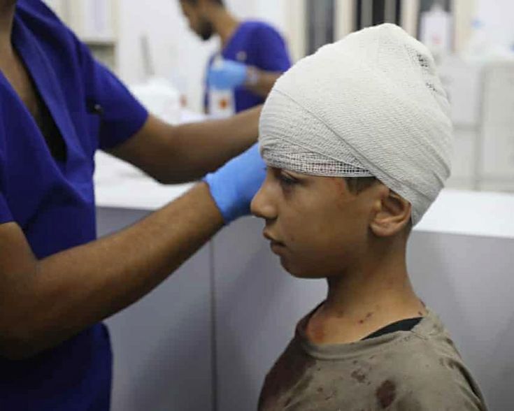 Palestinian child receiving medical treatment and playing football